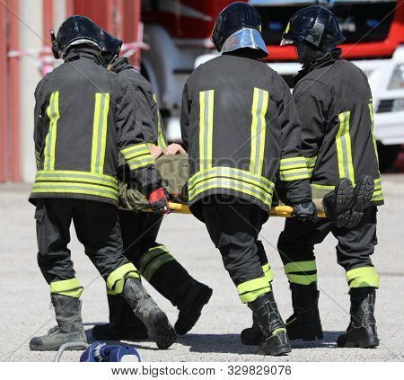 Four Stretcher Bearers Carring An Injured Person After The Road Accident