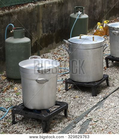 Cookhouse With Big Pots And Fire With Gas