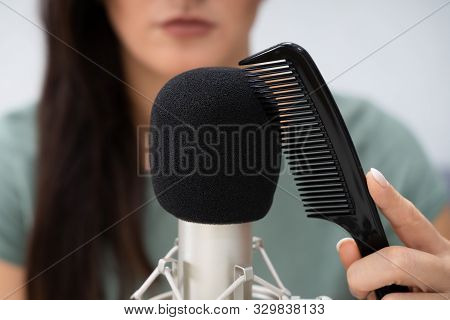 Woman Using Comb On Microphone To Make Asmr Sounds