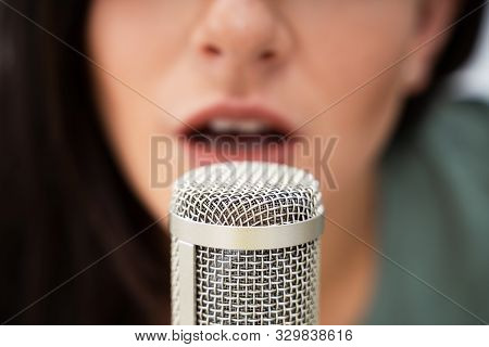 Young Woman Recording Asmr Sounds On Microphone