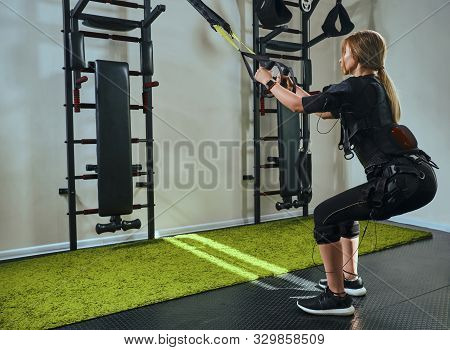 Beautiful Blonde Woman Wearing In Sensors And Belts, Fastens With Velcro Is Practicing Ems Fitness I