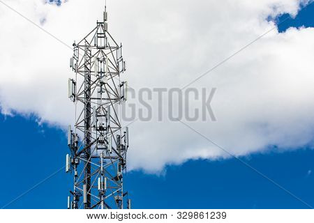 A Closeup View On The Top Part Of A 3g, 4g And 5g Mobile Communications Cell Tower With Antenna Tran
