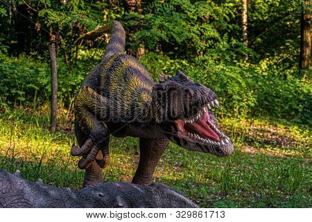 Belgorod, Russia - May 31, 2019: Full-size Deinonychus Statue In The Forest Of Belgorod Dinopark. Ca