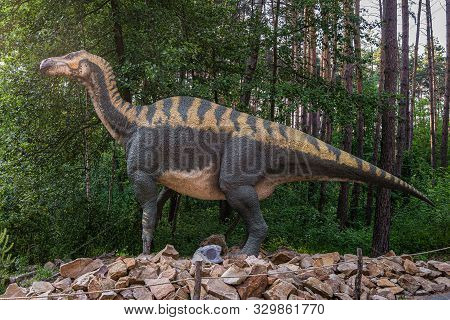 Belgorod, Russia - May 31, 2019: Full-size Iguanodon Statue In The Forest Of Belgorod Dinopark. Side