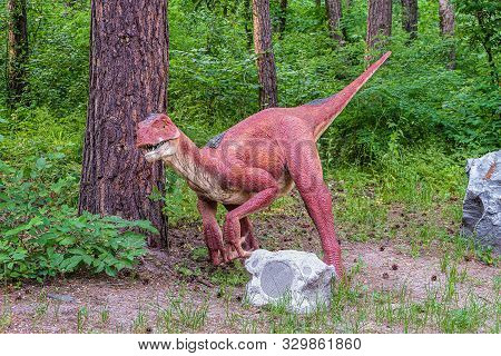 Belgorod, Russia - May 31, 2019: Full-size Velociraptor Statue In The Forest. Dinopark Of Belgorod C