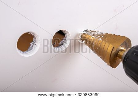Conical Drill Used For Small Housework. Drilling In Plastic With Tool Steel Drills. Light Background