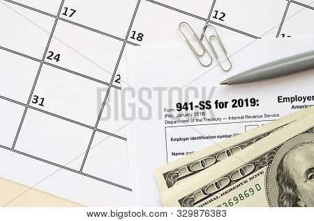 Irs Form 941-ss Employers Quarterly Federal Tax Return Blank Lies With Pen And Many Hundred Dollar B