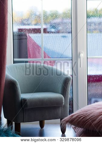 Lovely Pastel Blue Armchair Against The Floor-to-ceiling Window. Fragment Of The Interio
