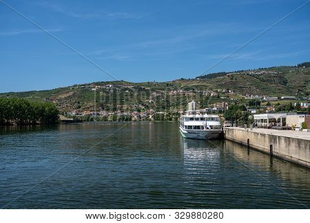 Regua, Portugal - 13 August 2019: River Cruise Boat Fernao De Magalhaes Docked By The Side Of Douro 