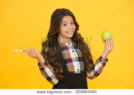 Brush Teeth Right Way. Happy Child Hold Tooth Brush And Green Apple. Teaching Oral Hygiene. Dental H