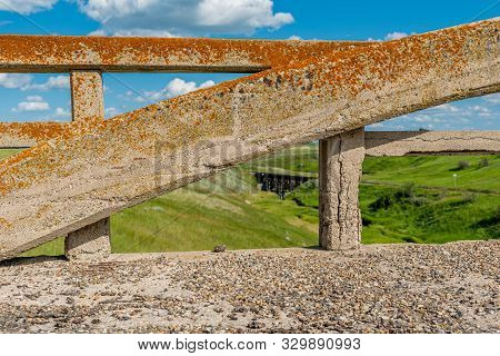 Lichen-covered Arch From The Concrete Bridge In Scotsguard, Sk With A Historic Railway Tressle In Th
