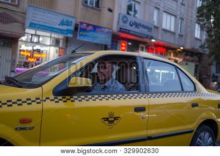 Tabriz, Iran - 11 August 2019 : Taxi, taxi driver and taxi passenger in Tabriz, Iran