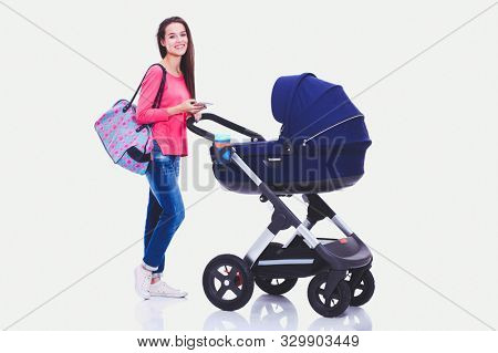Full length portrait of a mother with a stroller, isolated on white background. Young mom