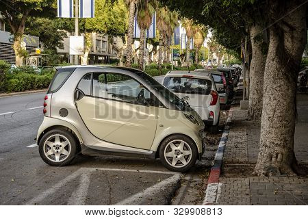 Israel. Tel Aviv. 07.04.2018. A Mini Car Is Parked Across A Parking Space Along The Road