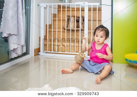 Little Adorable Girl Sitting And Playing In Living Room