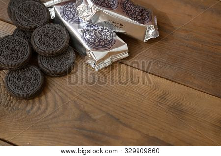 Oreo Sandwich Cream Biscuits Mini Packs And Cookies On Dark Wooden Background