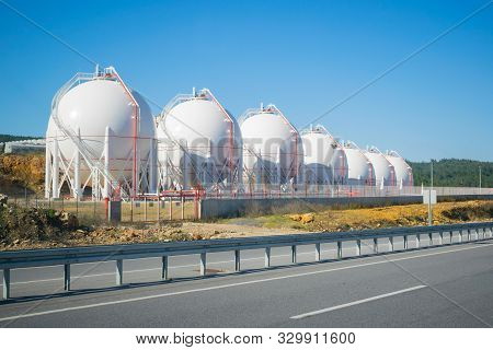 Lng Storage Tanks On A Roadside. Sunny And Clear View.