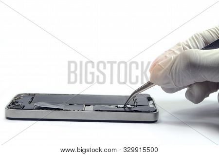 Phone Repairs Install Battery Into The Motherboard For Smartphone By Technician On Desk, With Mini T