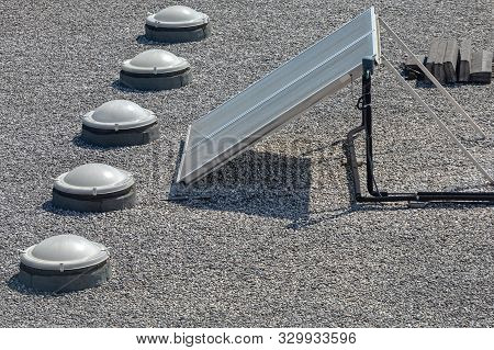 Solar Cells And Skylight Windows At Gravel Flat Roof