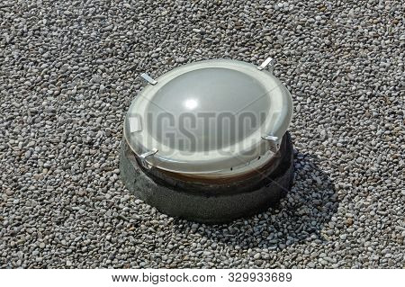 Open Skylight Window At Gravel Flat Roof Building