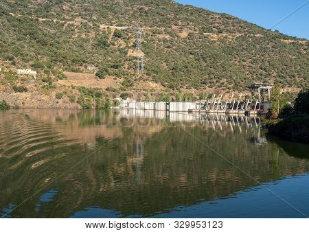 Solid Structure Of The Valeira Dam On River Dourowith Lock And Gates On The Left
