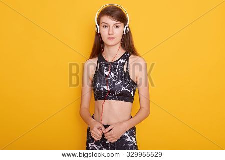 Picture Of Attractive Fitness Girl Wearing Sportwear Posing Isolated Over Yellow Background, Ready F