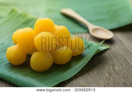 Thai Traditional Desserts  Gold Egg Yolks Drops  On The Banana Leaves , Wooden Top Table
