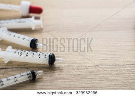 Empty Syringes Barrel On The Wooden Table With Copy Space.