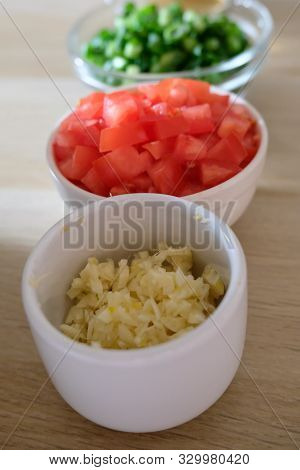 Vertical Row Of Bowls Of Minced Vegetables
