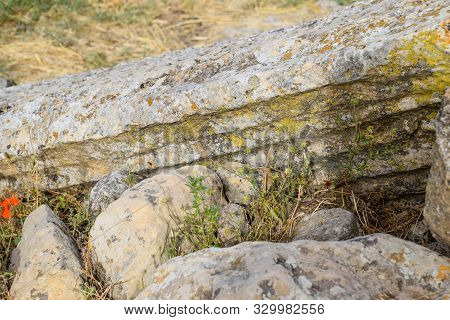 Fragments Of Ancient Buildings, The Ruins Of The Ancient City Of Hierapolis. Stone Blocks With Trace