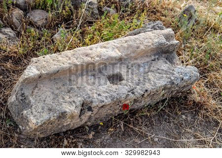 Fragments Of Ancient Buildings, The Ruins Of The Ancient City Of Hierapolis. Stone Blocks With Trace
