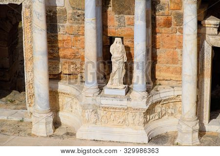 Marble Statues At The Columns Of The Amphitheater In Hierapolis, Turkey. Ancient Antique Amphitheate