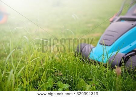 Lawn Mower Machine In Garden. Garden And Lawn Care Theme. Care Services Area