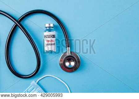 Vaccine bottles covid - 19 delta variant, vials medicine and syringe injection isolated on blue. Coronavirus DELTA 2019-ncov.