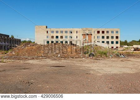 An Industrial Forbidden Territory With A Vacant Lot And An Abandoned Building. A Closed Enterprise W