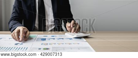 Businessman Sits In A Private Office At His Company And Is Reviewing Company Financial Documents, Se