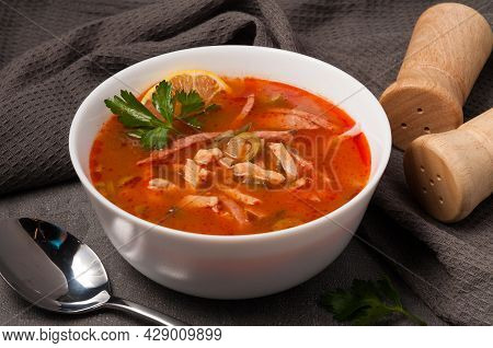 Traditional Russian Soup Solyanka In A White Bowl