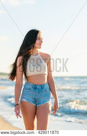 Lonely Young Woman Walking On The Beachsunset Day.beach Woman In Fashion Beachwear Relaxing Walking 
