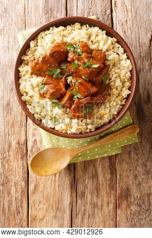 Afelia Cypriot Braised Pork With Bulgur Pilaf Closeup In The Plate On The Table. Vertical Top View F