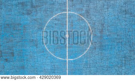 Multi-sport Court With A Central Circle And A Floor Painted Blue And Weathered