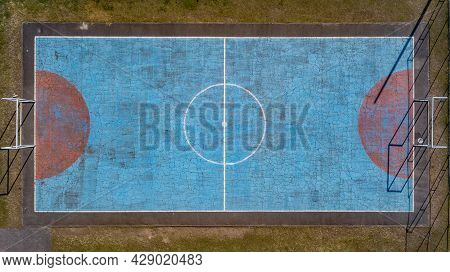 Multi-sport Court With A Central Circle And A Floor Painted Blue And Weathered