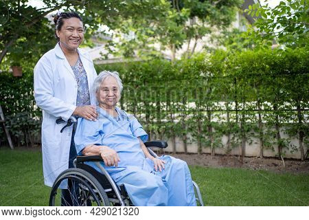 Doctor Help And Care Asian Senior Or Elderly Old Lady Woman Patient Sitting On Wheelchair At Park In