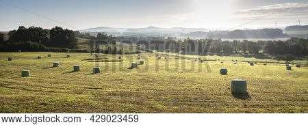 Foggy Early Morning Landscape With Hay Bales In French Ardennes Near Charleville In Northern France