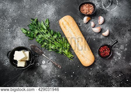 Ingredients For Garlic And Gerbs Bread Baguette Set, On Black Dark Stone Table Background, Top View 