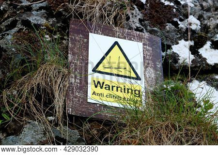 Anti Climbing Spikes Warning Sign On An Old Stone Castle Wall