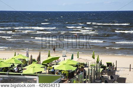 Latvia, Jurmala, July, 2021 - People Enjoying Relaxing On The Baltic Sea Beach In Jurmala, Latvia. H