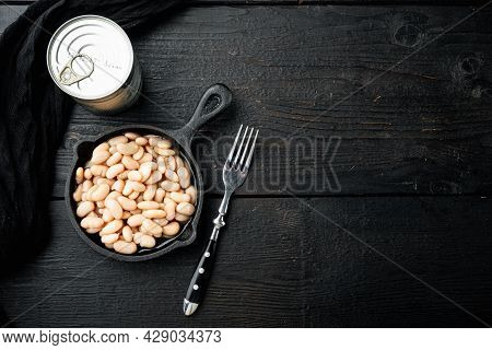 White Canned Kidney Beans Set, With Metal Can, In Cast Iron Frying Pan, On Black Wooden Table Backgr