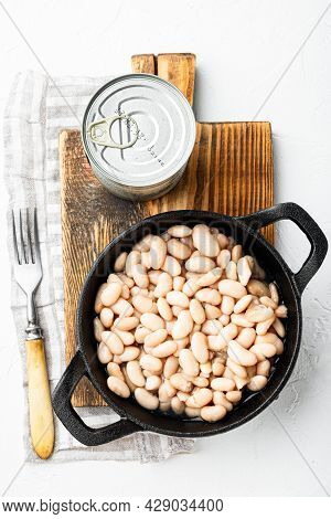 White Canned Kidney Beans Set, With Metal Can, In Cast Iron Frying Pan, On White Stone  Surface, Top
