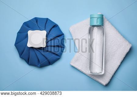 Bottle Of Water, Cold Compress And Towel On Light Blue Background, Flat Lay. Heat Stroke Treatment