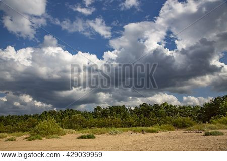 Cumulus Clouds Over Wild Sandy Coast Of The Baltic Sea In Vecaki, Latvia